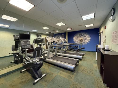 a gym with treadmills and cardio equipment in a room at The Peoria Hotel, SureStay Collection by Best Western in Peoria