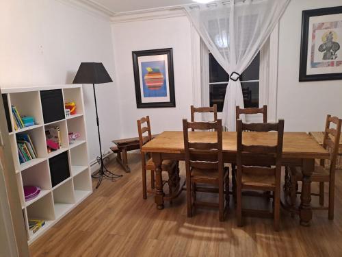 a dining room with a wooden table and chairs at Grand appart 2 chambres - max 6 pers in Vrigne-aux-Bois