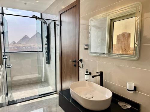 a bathroom with a sink and a glass shower at Lotus signature hotel in Cairo