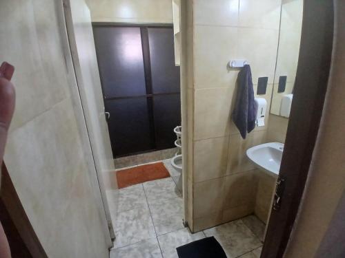 a bathroom with a sink and a toilet and a shower at El Guembe Hostel House in Puerto Iguazú
