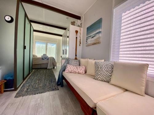 a living room with a white couch and a bedroom at Casa Azul Experience at The Perry in Key West