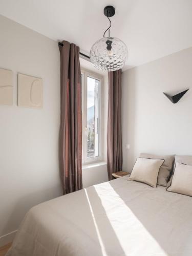 a bedroom with a white bed and a window at Marrakech - Gare - CEA - STMicro in Fontaine