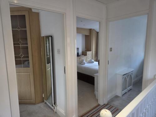 a room with a bedroom with a bed and a mirror at Comfy Home- Coley Park in Reading