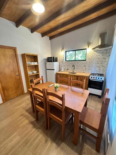 a kitchen and dining room with a wooden table and chairs at Refugio del Mar 2 in Ocean Park