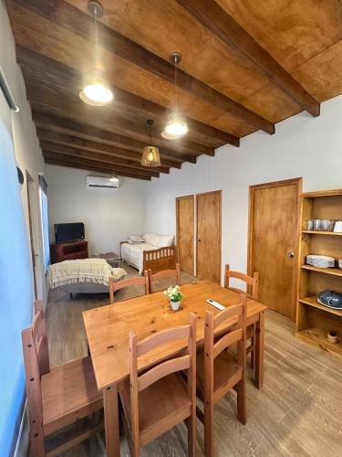 a dining room with a table and a bedroom at Refugio del Mar 2 in Ocean Park