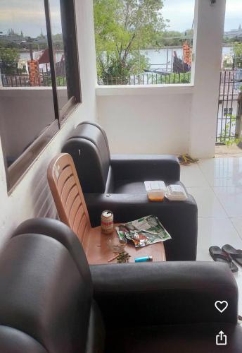 a living room with two couches and a table at Kampot Riverside GuessHouse in Phumĭ Ândong Pring