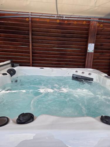 a jacuzzi tub in a room with blue water at Les hauts de beline Salines in Le Gosier