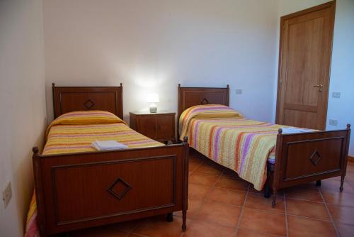 Giường trong phòng chung tại Immersi nella Natura