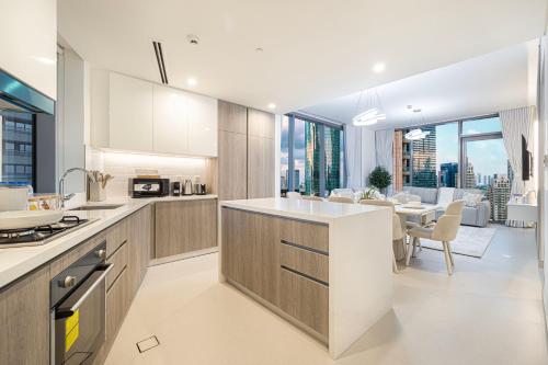 an open kitchen and dining room with a view of the city at Marina High-Floor Premium Luxury Stay at LIV Marina for up to 9 Guests with Marina Views and Exceptional Amenities in Dubai