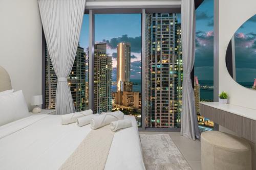 a bedroom with a large window with a city skyline at Marina High-Floor Premium Luxury Stay at LIV Marina for up to 9 Guests with Marina Views and Exceptional Amenities in Dubai