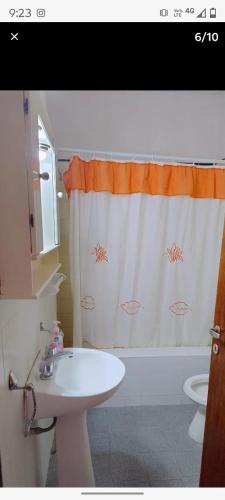 a bathroom with a sink and a shower curtain at Alas termas in Termas de Río Hondo