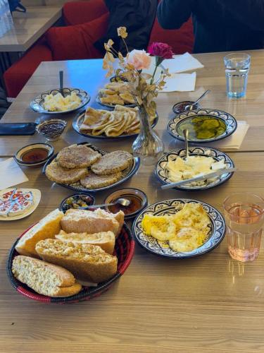 a table topped with plates of bread and eggs at Dar Romane in Tangier