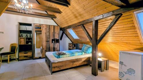 a bedroom with a bed and a wooden wall at Apartment da Luiz Salvatore in Wurmlingen