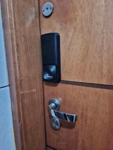 a door with a security box on a wooden door at Studio Lapa in Rio de Janeiro
