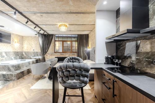 a kitchen with a table and a chair in a room at Basanavičiaus apartament in Vilnius