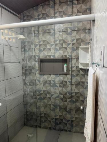 a bathroom with a shower with a glass door at Chalé Mirante do Lago Cotijuba in Belém