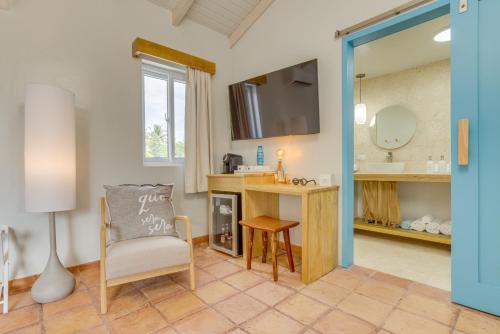 a room with a desk and a chair and a mirror at Blue Reef Beach and Marina in Placencia