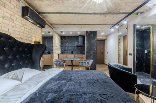 a bedroom with a bed and a table and chairs at Basanavičiaus apartament in Vilnius