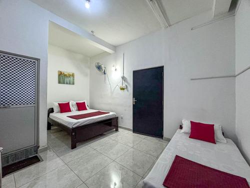 a bedroom with two beds and a door in it at Dee Ella hotel in Danowita