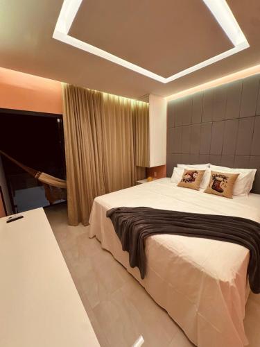 a bedroom with a large bed in a room at Mahalo Exclusive Boutique in Maragogi
