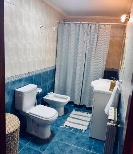 a bathroom with a toilet and a sink at Las Margaritas in Ushuaia