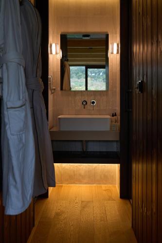 a bathroom with a large sink and a mirror at Mad Swans in The Mendips in Farrington Gurney