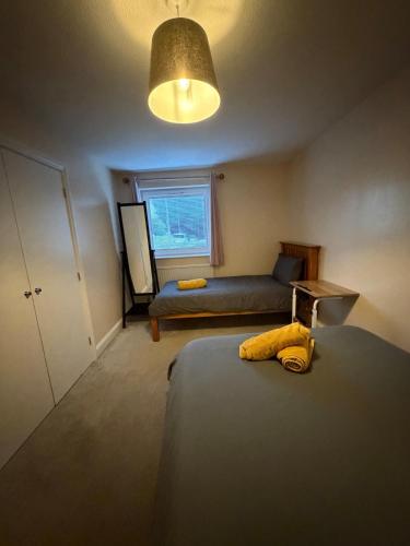 a bedroom with two beds and a window at 2 Bedroom Ground Floor Flat with Kitchen & Parking in Uxbridge