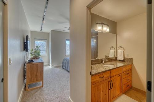 a bathroom with a sink and a mirror at Riverfront Perch, w Balcony over the River in Salida