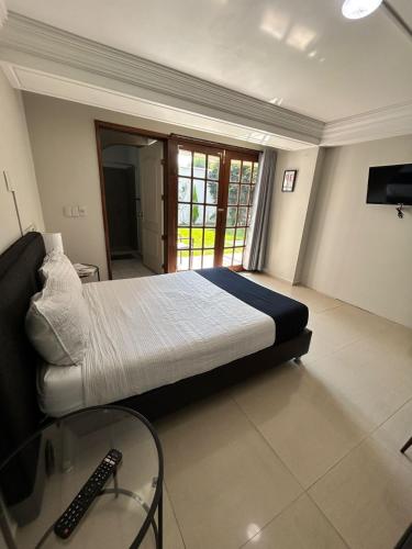 a bedroom with a large bed and a glass table at Singular Coyoacán Pepper My Love! in Mexico City