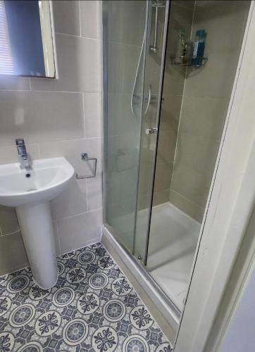 a bathroom with a shower and a sink at Dodi Aparts London, near Stratford close to tube station in London