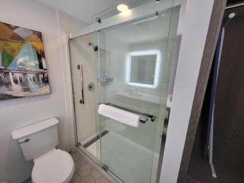 a bathroom with a toilet and a glass shower at DoubleTree by Hilton Salisbury in Salisbury