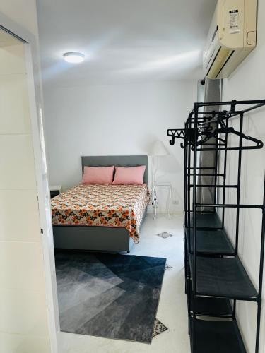 a bedroom with a bed and a spiral staircase at Pousada Montblanc suíte 4 in Guarujá