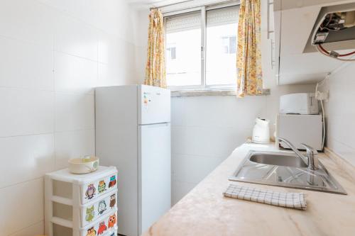a small kitchen with a sink and a refrigerator at Lisbon Tagus River&Terrace Flat in Lisbon