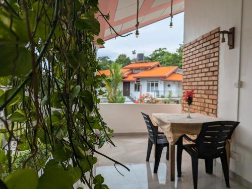 a patio with a table and chairs and a house at Condo NÖJE in Weligama