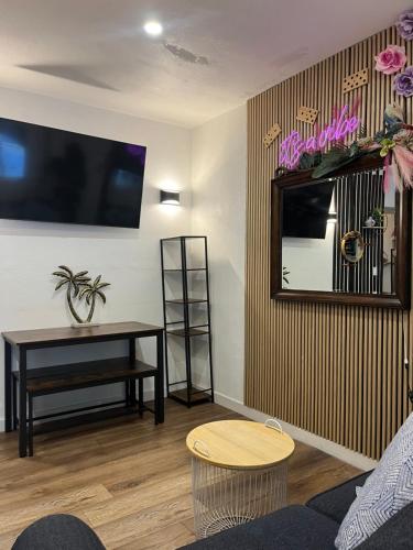 a living room with a table and a mirror at Stunning Little Havana Suites Close to airport, Calle Ocho, Brickell, Wynwood and the Beaches - Free Parking in Miami