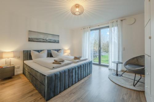 a bedroom with a large bed and a large window at Konny in Gaienhofen