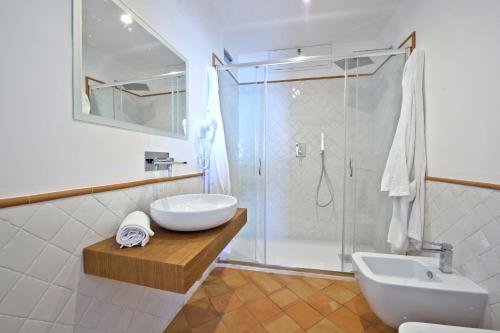 a bathroom with a shower and a sink and a toilet at Casa Cinque in Positano