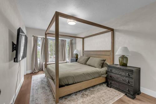 a bedroom with a canopy bed and a dresser at Lehi High Luxe Views and Sky in Lehi