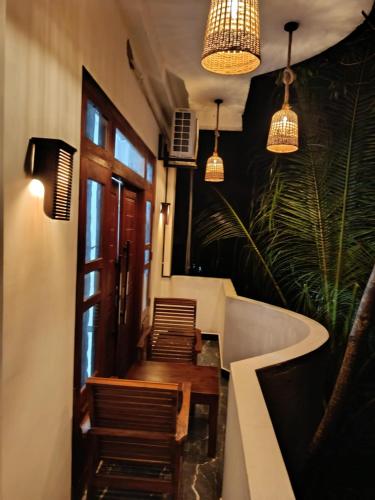 a room with a table and chairs and lights at Isurindi Villa in Midigama East