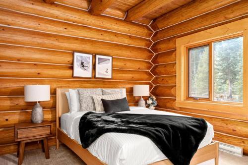 a bedroom with a bed in a log cabin at Rustic Cabin Hideaway with BBQ Fire Pit and Mtn Views in Golden