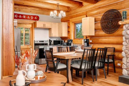 a kitchen and dining room with a table and chairs at Rustic Cabin Hideaway with BBQ Fire Pit and Mtn Views in Golden