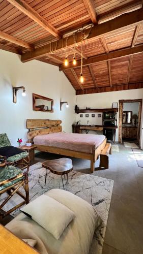 a large room with two beds and a table at Casa Refúgio com suíte e lareira! in São Miguel da Serra