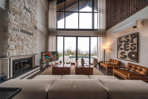 a living room with a couch and a fireplace at Voger Sapanca Lake View in Sapanca