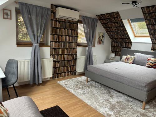 a bedroom with a bed and a bunch of books at Oliver's House in Budaörs