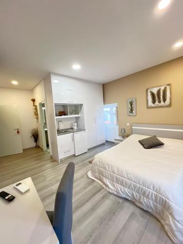 a hotel room with a bed and a desk and a table at Casa da Moagem in Vinhais