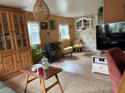 a living room with a large flat screen tv at Het Heideverblijf in Heerlen
