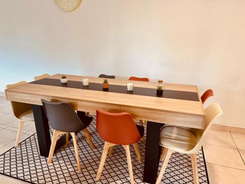 einen Tisch in einem Raum mit Stühlen in der Unterkunft Beauséjour in Saint-Herblain