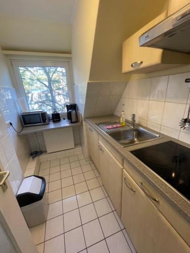 a small kitchen with a sink and a window at Seepferdchen in Timmendorfer Strand