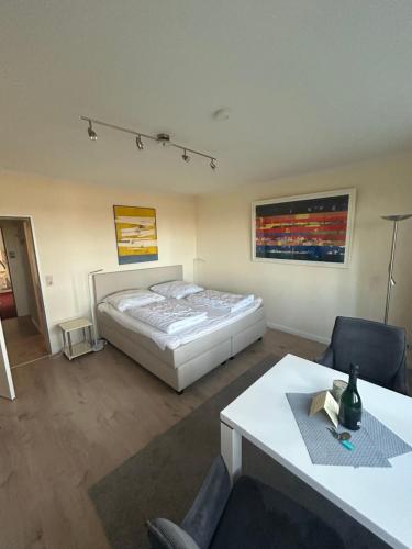 a bedroom with a bed and a table in it at Seepferdchen in Timmendorfer Strand