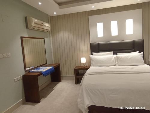 Giường trong phòng chung tại لؤلؤة راحتي للشقق الفندقية